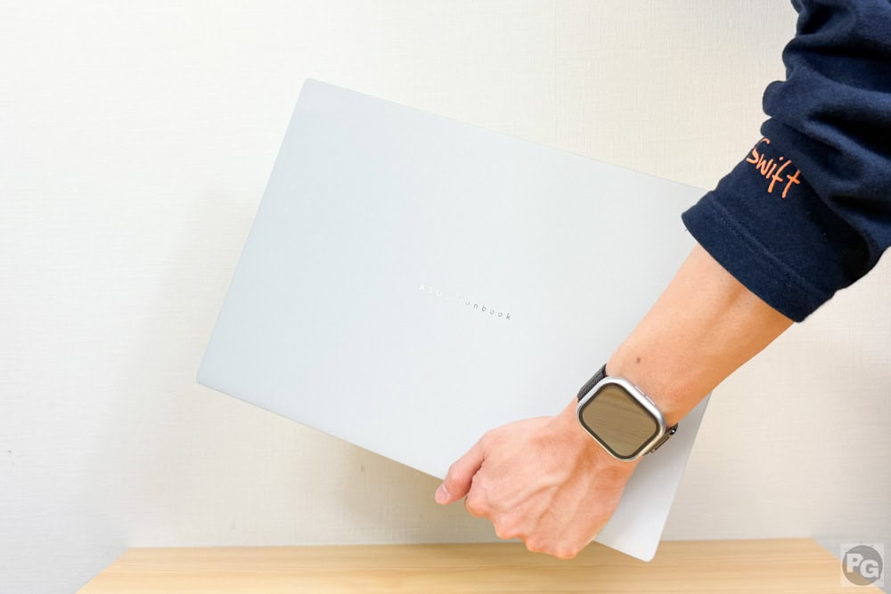 ASUS Zenbook S16 (UM5606)を片手で楽に持ち運んでいる画像